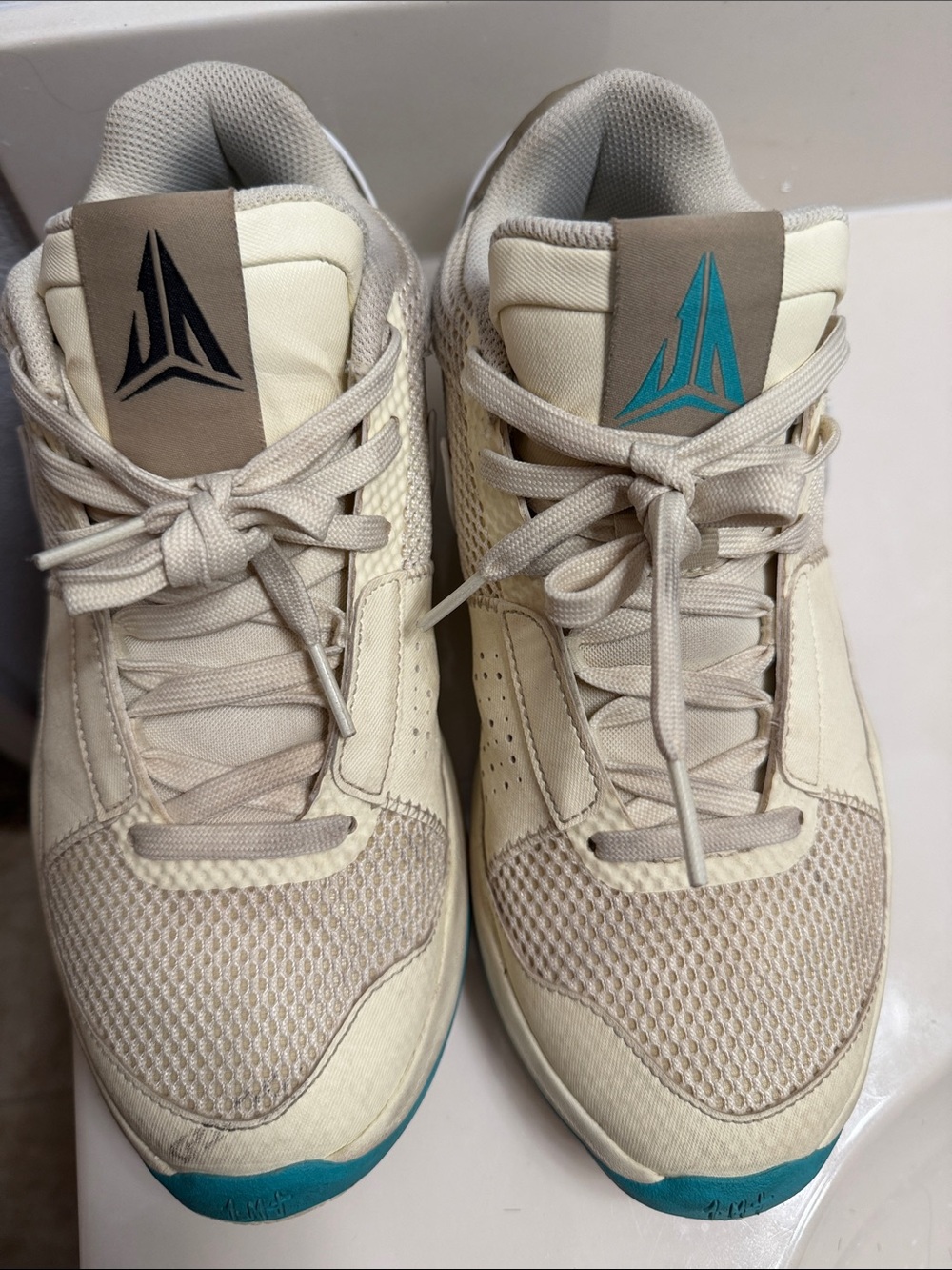 Nike Cream Sneakers with Teal and Black Logo Accents